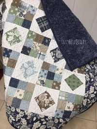 I love this baby girl quilt! 💕These fabrics are so fun! Florals, plaids, and polka dot fabrics in blues, greens and brown. The fabrics coordinate beautifully. I quilted it with a floral paisley stitch. The binding is doubled and hand stitched together for a durable seamless finish. The backing is navy minky and it is so soft. Sadly this is my only one.  It is made in a clean smoke free, pet free environment. Machine wash on a delicate cycle, in cold water. Dry on a low temperature setting.