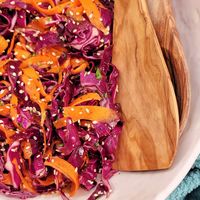 Flavorful Asian slaw with loads of carrot, red cabbage, and a sprinkle of sesame seeds is a fresh twist on classic slaw recipes.