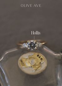 14K Yellow Gold | Hollis features a stunning cushion center stone with two pear side stones set in a three stone basket on a half round shank.