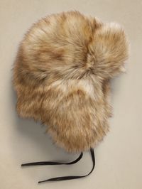 Capturing the essence of true Toscana shearling with this vegan-friendly version, this aviator-style hat relies on fluffy, long-hair faux fur for maximum warmth.  Crown Cap: Since 1934, the expert craftsmen at Canada's Crown Cap have produced superior headwear and accessories, working with exquisite materials to create exceptional and stylish cold-weather essentials.  Ear flaps and chin strap.  Fully lined.  To find the best fit, consult the size chart below: