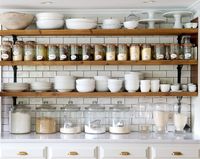 The first thing Ms. Green did after moving in was to yank out the upper cabinets in the kitchen and replace them with shelving from Home Depot.