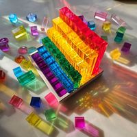 Beautifully exclusive hand made set of cube and rectangle blocks in a cardboard (6 pieces set ) or wooden tray (12, 24 or 42 pieces set).  High clarity and transparent lucite blocks can be incorporation into play in so many play possibilities. The smallest cube is 2.5cm long and goes up to 15 cm long in 2.5cm increments. Lengths are 2.5, 5, 7.5, 10, 12.5 and 15cm and each blocks size is 2.5cm thick. Recommended Age: 3+ years