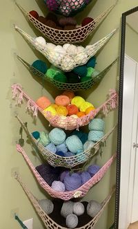 This is my yarn stash. I created 3 pointed hammocks and used clear adhesive hooks to give it a seamless look. Adhesive hooks in links.