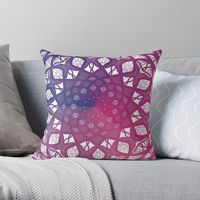 A throw pillow with an intricate mandala pattern radiating from the center star, gradually changing colors in a gradient from blue to purple to pink and back again.