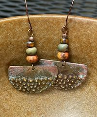 Rustic antique Hammered copper dangle earrings with jasper stones.  Looking for something lightweight, unique and natural? This simple yet elegant pair of hammered copper earrings will definitely make you smile!  These earrings have a very unique hammered texture. The color of the copper changes with the light. They have an antique patina finish for a rustic look. The stones are varieties of jasper.  These earrings are 1 inch in diameter. They are very light weight, less than 3 grams. The French