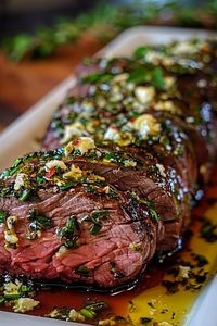 Herb Butter Beef Tenderloin Roast  Ingredients:  4 lbs beef tenderloin roast, trimmed 4 tbsp olive oil 1 stick (½ cup) unsalted butter, softened 2 tbsp fresh rosemary, minced 2 tbsp fresh thyme, minced 3 garlic cloves, minced 1 tbsp Dijon mustard 1 tsp salt 1 tsp black pepper  Instructions:  Preheat oven to 425°F. Pat the tenderloin dry and season with salt and pepper. Heat olive oil in a skillet and sear the roast on all sides until browned. In a small bowl, mix butter, rosemary, thyme, garlic, and Dijon mustard. Spread the herb butter over the roast. Place it on a roasting rack in a pan. Roast for 25-30 minutes for medium-rare (internal temp 135°F).   Prep Time: 10 mins | Cook Time: 30 mins | Total Time: 40 mins | Kcal: 450 | Servings: 8