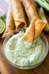 These chicken taquitos are filled with a sprinkle of corn and pepper jack cheese, plus come with an avocado ranch dipping sauce on the side! | thecozyapron.com #chickentaquitos #chickentaquitosrecipe #chickentaquitosfried #chickentaquitosrecipefried #avocadoranch