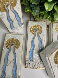 "These blessed Mary's are created on wood and have tons of sparkle. There are textured flowers at the bottom. The entire piece is accent in gold leaf, glass and resin. There are different sizes that I offer on wood and several different sizes in canvas. Please read the difference between the wood and canvas in the \"NOTE\" below to help you decide which one you would like. If you would like a custom size please message me for a custom quote. NOTE: Difference between wood and Canvas - The wood is actually boards of lumber that I cut into squares or rectangles so the measurements are a little bit smaller than the canvas. The canvas is the exact size that you order.  - The back of the wood is painted to give it a finished look and has a hook. The back of canvas also has a hook. -The depth of