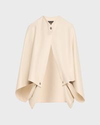 "Find LORO PIANA Buttoned Cashmere Cape on Editorialist. Loro Piana cape in cashmere Approx. 21.6\"L x 3.1\"W Button closure Cape sleeves with button closures Asymmetric hem Item Weight (Lbs.): 1.1 Dry clean Made in Italy"