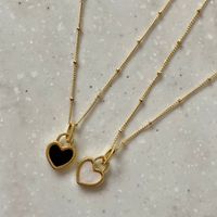 the double sided oreo necklace can be worn two ways, as the pendant is black on one side, and white on the other! one side is white whilst the other side is black, all in one necklace! material: 18k gold plated or silver plated on stainless steel length: 40cm+ 5cm adjustable