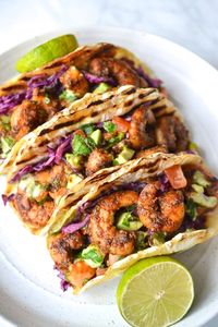 These Spicy Shrimp Tacos are truly THE BEST tacos that just happen to be Whole30!  The grilled celery root tortillas are packed with a creamy coleslaw, spicy shrimp and a simple avocado and tomato salsa, so simple but so incredibly tasty! These are a real crowd pleaser that everyone will enjoy.