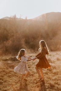 Capture the magic of childhood as these two best friends enjoy a playful moment in the grass. Their laughter is contagious as they hold hands and explore the world together. #bestfriends #childhoodmemories #playfulmoments #laughter #exploringtheworld