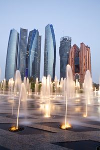 Etihad Towers, Abu Dhabi viewed from the Emirates Palace Hotel fountains.