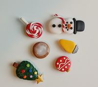 Cute Christmas magnet set for the white board or refrigerator. Great for bringing the holidays to the office or school or right in your own home! Set includes Yellow Christmas light, Christmas tree, Gingerbread cookie with icing, Christmas ball, Candy cane lollipop, and snowman. All pieces are handmade and may differ slightly from picture.