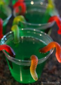 Gummy Worm Jello Cups with other spooky gummy candies like a witch potion.