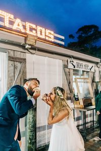 bride and groom at taco spot, cinco de mayo wedding ideas, tacos instead of cake, wedding cake alternatives