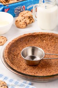 All you need are two ingredients to make this easy Chocolate Chip Cookie Pie Crust. It is the perfect addition to pies or cheesecake.