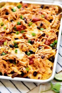 Sheet Pan Chicken Nachos are a must-make for game day or any party. Seasoned shredded chicken, black beans, cheese and more all loaded on top of tortilla chips! Friends, these Sheet Pan Chicken Nachos are my new food obsession. These nachos are dangerously good and packed with lots of flavor! I used this incredible SLOW...