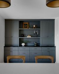 Blue built in cabinets, shelving, dark counter top, shiplap in kitchen