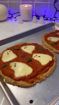 The cutest little Halloween pizza for Halloween dinner 🍕👻 Ghosts: Pre-sliced mozzarella cut into ghosts using a sharp knife Chopped olives for the eyes