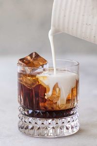 A quick recipe and everything you need to know for how to make a white Russian! This classic cocktail combines vodka, Kahlua and cream. We whipped some of the cream and added it to the top for a whipped white Russian. It's a fantastic cocktail and simple to make. #WhiteRussian #Cocktails #CoffeeCocktail #Kahlua