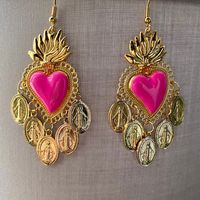 Beautiful pair of Chandelier Earrings Sacred Heart in a beautiful fuchsia/shocking pink and miraculous Madonnas hanging! Hand enamelled by me Very light, each earring weighs just over 5g.!! Length approximately 6 cm. Materials: Steel hook Alloy sacred heart Aluminum Madonnas If you want to purchase a larger quantity than available, write me a message. Please note: Colors may appear different depending on your viewing device. 💌Shipping: IN CASE OF MULTIPLE ITEMS, YOU WILL PAY ONLY ONE SHIPPING!