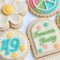 Jessi | Ms Whisk on Instagram: "49 and Forever Young! This groovy birthday set has a ✌️💛😊 vibe along with the infamous Windsor glasses of John Lennon, one of the birthday girl’s favorite artists. • • #buttercreamsugarcookies #buttercreamcookies #cookiesofinstagram #instacookies #sugarcookies #buttercream #decoratedsugarcookies #buttercreamcookiers #instabaker #inspiredbybuttercream #ohiosmallbusiness #hippiecookies #peaceloveandhappiness #groovycookies"