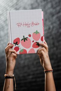 This strawberry designed Bible by Savannah at Joyful Pine is so very SWEET indeed! We love this Bible so much! It features a professionally printed cover - NO, not hand painted but PRINTED professionally in-house for the ultimate in quality and durability. You're going to LOVE this bible! + SPECS + + New Updated High Quality Hardboard with Fabric cover+ Single column, paragraph format, 7.5 font+ Crossway ESV Journaling Bible+ Cream-colored paper+ Ribbon marker+ 2" ruled margins for writing+ 6.25 in x 8.0 in+ Perfect size for taking to church+ Professionally printed in-house Please note that the spine will have a small gap in the print where the book bends. Since all our items are printed in-house, there might be a slight difference between the product preview and the finished printed resul