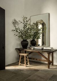 Moody, organic entry with wood console table