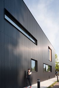 Mercer Island Fire Station by Miller Hull Corrugated metal clads exterior walls, with red cedar used to accent windows and entryways.