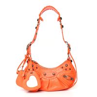 This is an authentic BALENCIAGA Agneau Arena Le Cagole Shoulder Bag XS in Orange. This stylish and structured handbag is crafted of soft orange lambskin leather. The bag features a sturdy leather top handle with silver links, a top zipper, and an adjustable shoulder strap. The top unzips to a black fabric compact interior.