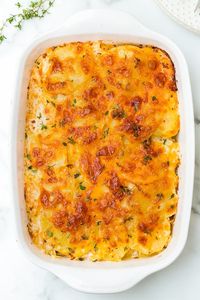 A delicious Scalloped Potato Gratin recipe made with thinly sliced Yukon gold potatoes layered with cheese and a light buttery sauce. #scallopedpotatoes #potato #skinnytaste #holidayrecipe #sidedish #thanksgiving #christmas