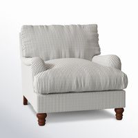 This armchair brings traditional farmhouse charm into any room. It's wrapped in upholstery that comes in a variety of fabric types, hues, and patterns to suit your space perfectly. Inside, a down and feather blend pairs with sinuous springs to give you just the right amount of support as you relax. This accent chair has a solid and engineered wood frame, and it rests on turned, tapered front feet. Recessed arms and a loose back round out the look with understated charm. Birch Lane™ Fabric: Cruis