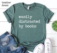 Easily Distracted By Books Shirt, Book Lover Shirt, Librarian Shirt, Gift For Bookworms, Readers Shirt, Funny Teacher Shirt. Reading Shirt Please Check All Photos for Details This listing is for 1 (one) shirt only, to buy more than 1 item please add each shirt to cart separately. --- SIZE AND MATERIAL --- * UNISEX CREW NECK T-SHIRTS: Most customers find unisex shirts true to size. Relaxed fit for ladies and they can order one size smaller for a further slim fit. Unisex crew neck shirts run a tou