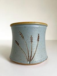 Beautiful one of a kind stoneware ceramic pottery planter bowl vase. Beautifully made with incised textured wheat design, and great blue/tan earth tone glaze. In excellent vintage condition with some very minor flea bites to the bottom rim. Beautiful planter pot for your home! Measures approx. 5.5" tall x 6.25" wide. - - -  Feel free to contact me with any questions.  MODOCADO [at] GMAIL.COM International orders - Please convo me for a shipping quote BEFORE purchasing the item.  Thanks for looking!