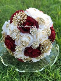 This beautiful bouquet is handmade with burgundy and cream roses with sparkling gold brooches. The design can be change if requested. I can do it in different colors. Please message me the color. I also have the gold and rose gold brooches available. *This bouquet is 10 inches in diameter* A boutonnière is included with the bouquet. Please contact me with any questions! :)