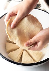 Pulling of the easy dough to make tortilla shapes