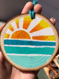 "Sunset design hand painted on a slice of wood. \"Aloha\" on the back and personalization can be added. Size of wood varies between 3 1/2- 4 inches in width.  Made with Aloha🌺"