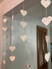 Heart shaped garland made from upcycled book pages, all strands are individual (not connected at the top). Perfect decor for a book club, birthday party for a bookish friend, or bedroom/library. Vertical strands come with 3 hearts (13 inches), 5 hearts (20 inches), or 7 hearts (30 inches) attached. Horizontal strand comes with 15 hearts attached and is 75 inches. Can be ordered in any combination of these different strands. Paper hearts attached to string with clear tape. *Please note: The product(s) you receive may vary slightly from the photos provided, as every item in my shop is individually handmade for each order. I hope you enjoy your purchase!