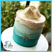 Sophisticated & modern ombre buttercream waves to go cake adorned with French macarons.