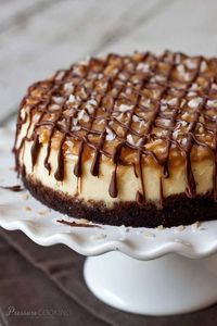 Samoa cheesecake is rich, dense New York style cheesecake with a crisp chocolate graham cracker crust. The top is crowned with a coconut caramel topping and finished with a drizzle of semi-sweet chocolate. #instantpot #cheesecake #samoa #pressurecookingtoday