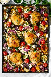 The best Greek sheet pan chicken dinner recipe! It's a blend of juicy chicken thighs, roasted vegetables, and the best Mediterranean flavors.