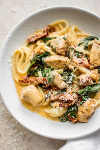 This creamy Tuscan chicken pasta recipe is even better than the Olive Garden's! You can quickly make this easy chicken, spinach, and sun-dried tomato pasta with a creamy garlic sauce at home in under half an hour!