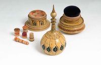 A REGENCY PAINTED WOOD SEWING COMPENDIUM c. 1815 Of architectural design, inspired by Nash's Brighton Pavilion, the dome enclosing a pin cushion, the lower section enclosing a compartment with sewing instruments.