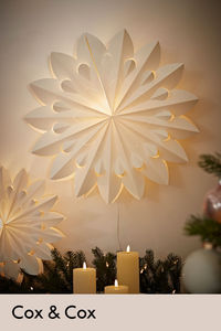 Inspired by the 70s style paper decorations, our light up paper stars add a warm glow to your home. In delicate neutral tones, the colour wonderfully combines with the 3D textural effect.

Hang on your wall, or simply position on top of a surface, like a sideboard, for a touch of retro inspired magic in your space.

A simple, timeless decoration to add to any Christmas collection.