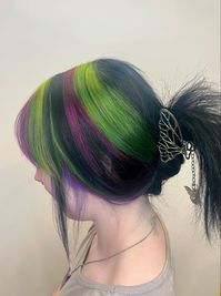 green, magenta, purple, black, striped hair. Chunky highlights