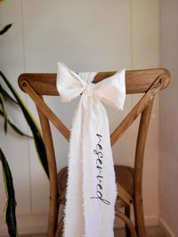 This listing is for a ''RESERVED" chair ribbon. A nice way to add a detail to a reserved seat at a special event. This ribbon is generous size - measuring 4'' wide and 130'' long and has natural teared fabric edges. With plenty of extra length for the ribbon to pool on the ground. If you do not like the ribbon to pool on the ground - you can cut it ( or cut and carefuly tear) to the length required. This sign can be personalized with a NAME OF YOUR CHOICE! Care: Machine wash up to 100oF ( About