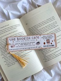 Purchase 2 or more items for free UK shipping! Please use promo code: FREESHIPPING ☕️ The bookish cafe book club 📚Perfect for book and coffee lovers 🍂 Cosy autumn fall vibes in brown and neutral tones for cosy homebody girlies Bookmark Details: - Bookmark dimensions: 19cm x 5.5cm (approx) - Printed in London on 300gsm quality linen matte card stock - Bookmarks are available with and without tassels (Please select) - Tassel colours varies - Curved edge detail - Blank at the back How To Order: - Select between with or without a tassel!  Shipping Details: As our products are made to order on a small scale, please allow 1-3 days for production, in addition to 2-3 working days for postage via Royal Mail. The total expected time frame is approximately 1 week. - Shipping from UK is 1-3 business