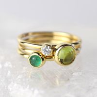 A stunning green peridot stacking ring made from solid 9ct yellow gold. Choose to wear the ring on its own, or mix and match it with other stacking rings from the Nebula collection, or why not add a sparkling Andromeda diamond ring?Peridot is a beautiful juicy green gemstone and the birthstone of August. It is one of only a few stones to come in only one colour, a lovely olive green and is said to bring a wonderful year to whoever wears it. It's warm glowing colour is a reminder of summer and of