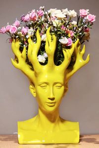 Have you seen such a beautiful design lately? This flower vase will turn your home decor game on the next level.

And no, it’s not the Medusa from the Ancient Greece myths. More like a Mali girl, with a magical hairdresser. The captive coral-looking branches, and some flowers, will freeze every look.

The calming face on the figure is transferable. The more you look, the more you fall in love with the amazing design. The sculpture, a flower vase, the art we fall in love with!